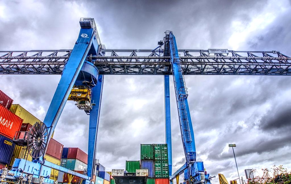 Container port on the Rhine with cranes and stacked shipping containers
